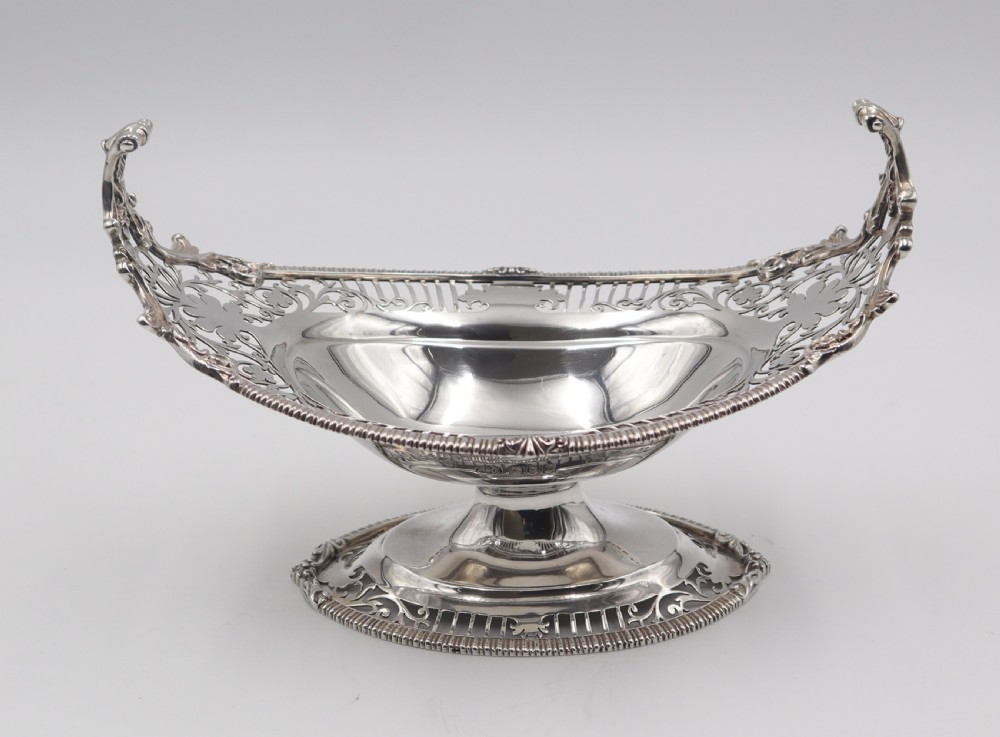 A pair of antique boat-shaped silver sweetmeat stands featuring pierced openwork borders and pedestal bases. View IV