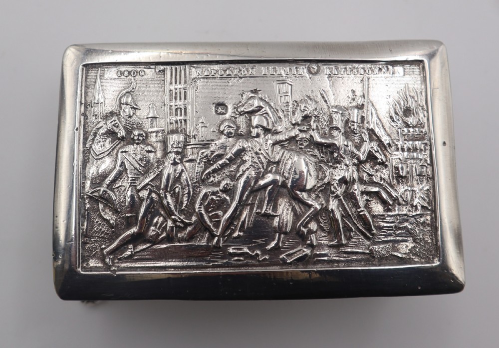 A rectangular silver trinket box featuring an embossed relief scene of Napoleon on the lid, ornate filigree side panels, and small raised ball feet. View VI