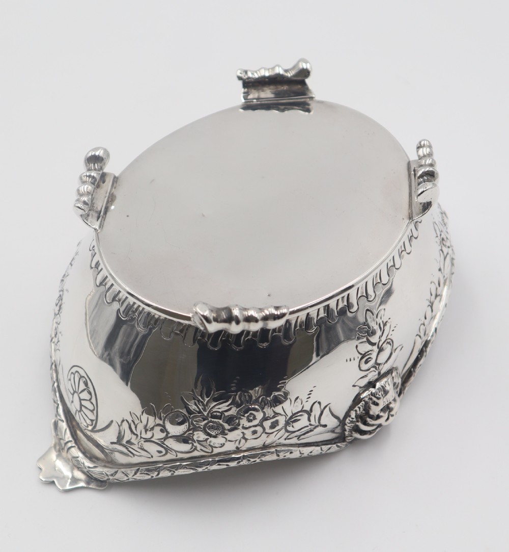 A pair of ornate antique silver bowls featuring embossed lion head masks, floral swags, gadrooned bases, and scroll feet. View VI