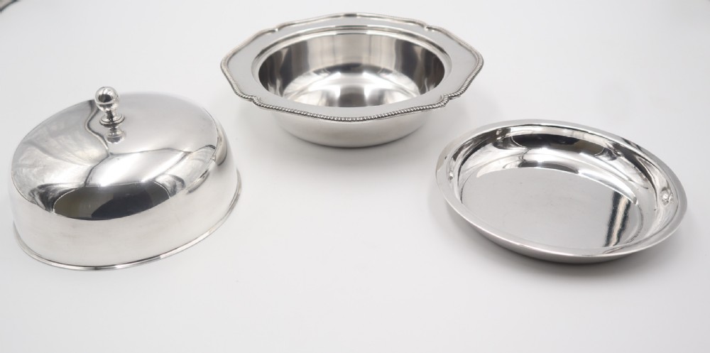 An antique silverplated muffin dish featuring a domed lid with a ball finial and a circular tray with a beaded edge. View III