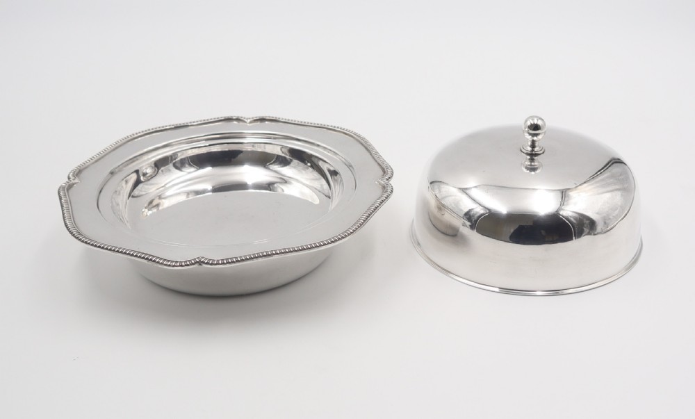 An antique silverplated muffin dish featuring a domed lid with a ball finial and a circular tray with a beaded edge. View IV