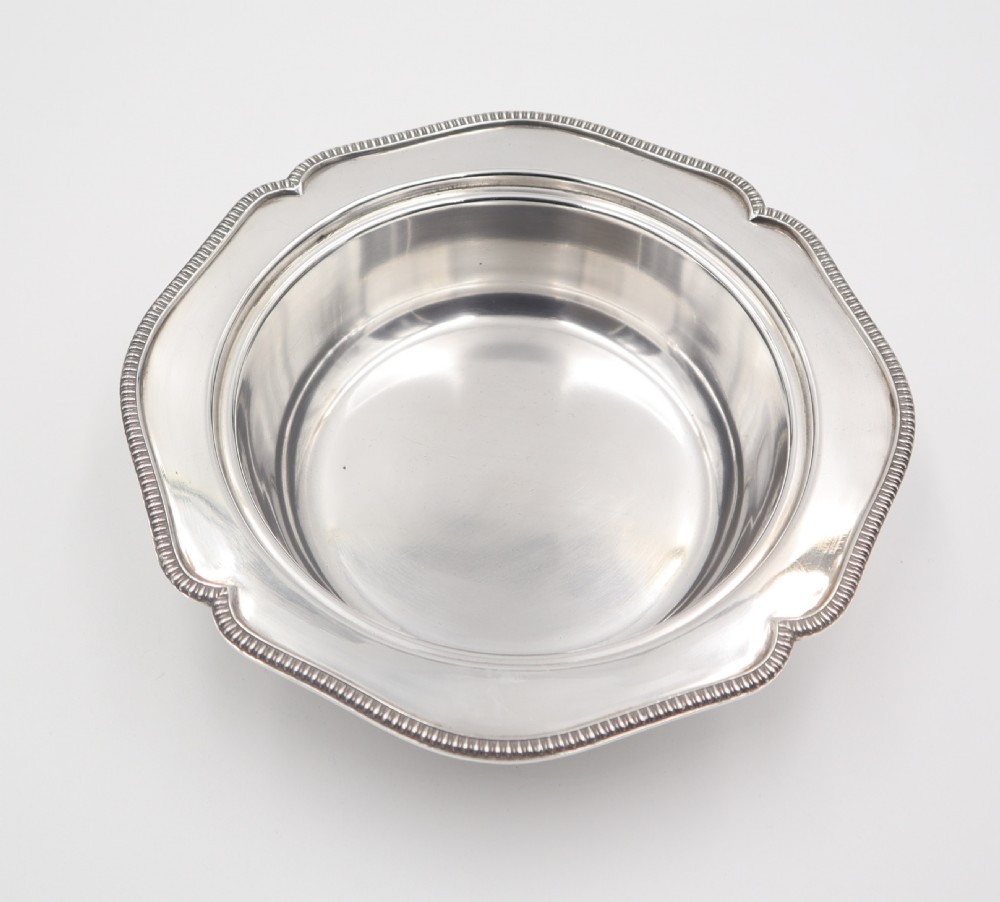 An antique silverplated muffin dish featuring a domed lid with a ball finial and a circular tray with a beaded edge. View VI