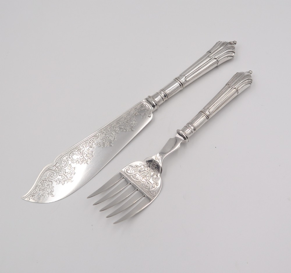 A set of antique silver-plated fish servers featuring an engraved serving knife and a matching four-tined fork with fluted handles. View II