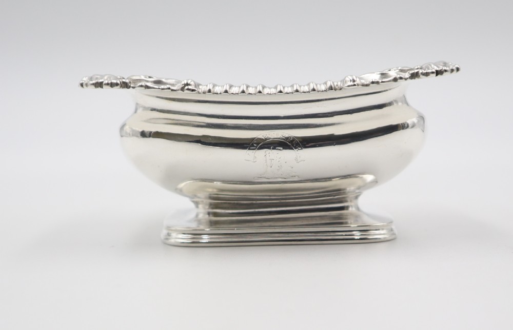 A set of five oblong sterling silver salt cellars featuring gadrooned borders, pedestal bases, and gilded interior bowls. View IV