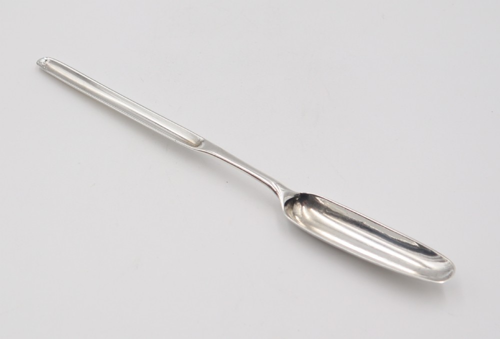 An elongated double-ended sterling silver marrow scoop with a narrow trough at one end and a broader trough at the other. View III