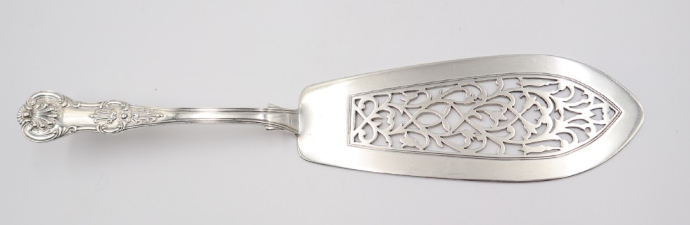 A two-piece set of silver fish servers comprising a pierced blade slice and a matching four-tined fork with decorative scroll handles. View IV