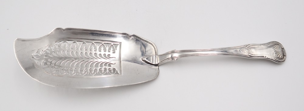 An antique sterling silver fish slice featuring a pierced engraved blade and a fiddle and shell pattern handle. View III