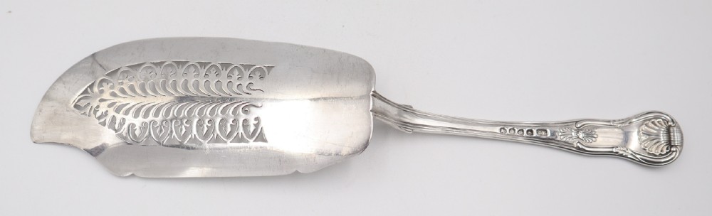 An antique sterling silver fish slice featuring a pierced engraved blade and a fiddle and shell pattern handle. View IV