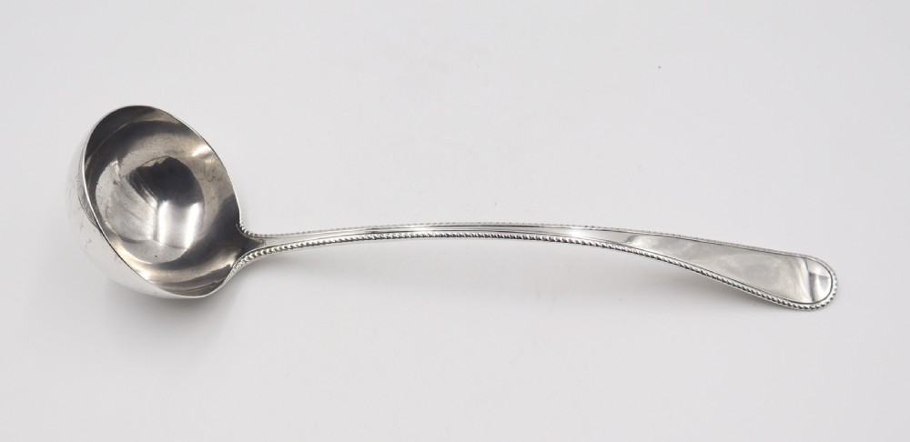 A pair of silver sugar tongs featuring a flexible plain bow, spiral twisted arms, and shell-shaped grips. View II