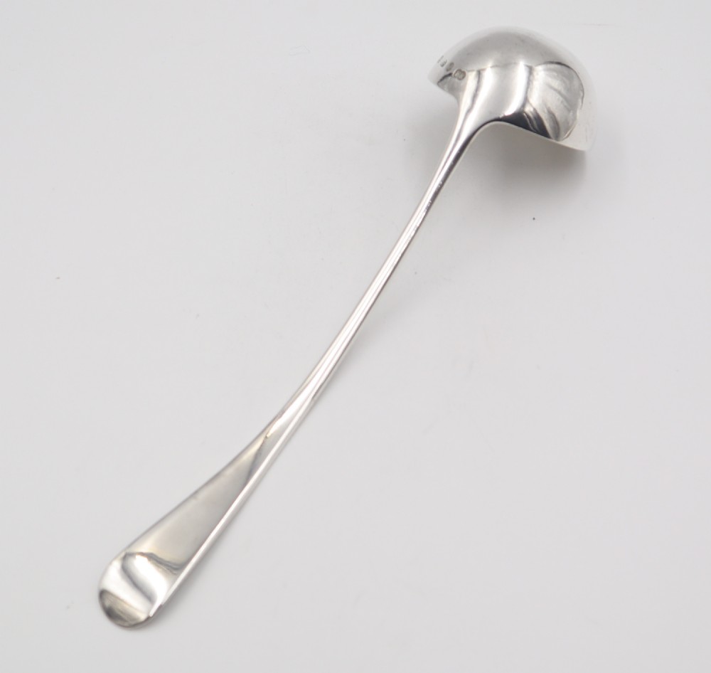 An antique silver soup ladle featuring a beaded rim pattern along the long curved handle and a deep circular bowl. View IV