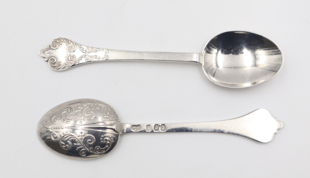 A set of six antique sterling silver teaspoons with intricate hand-engraved scrollwork on the reverse of the bowls and shaped terminals. View II