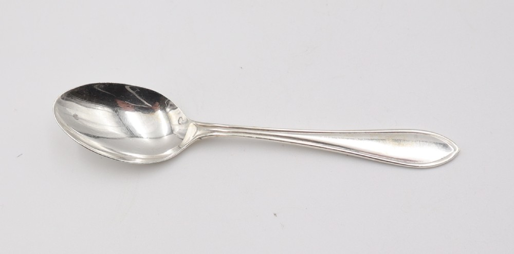 A comprehensive silver cutlery set containing dinner knives, forks, soup spoons, and dessert spoons laid out flat on a light grey background. View III