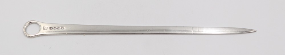 An antique sterling silver meat skewer with a tapered blade, stamped hallmarks, and a ring terminal against a neutral white backdrop. View II