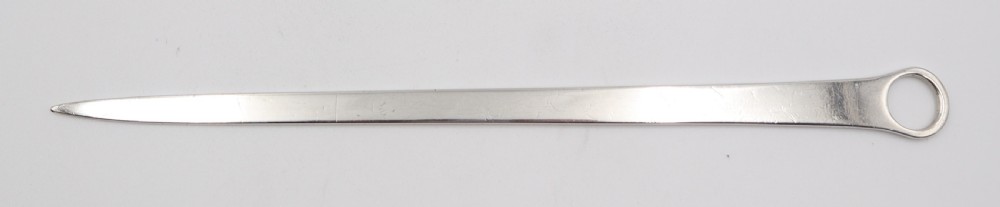 An antique sterling silver meat skewer with a tapered blade, stamped hallmarks, and a ring terminal against a neutral white backdrop. View IV