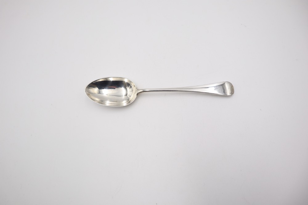 A complete antique silver cutlery set comprising table knives, forks, soup spoons, dessert spoons, and teaspoons arranged neatly on a white background. View IX