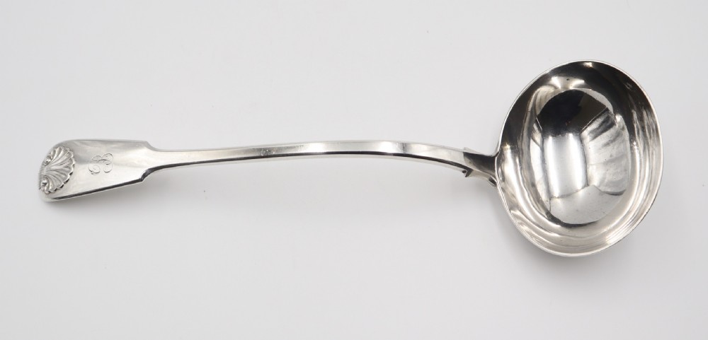 An antique silver soup ladle featuring a deep circular bowl, a slender arched stem, and a shell detail on the handle terminal. View II