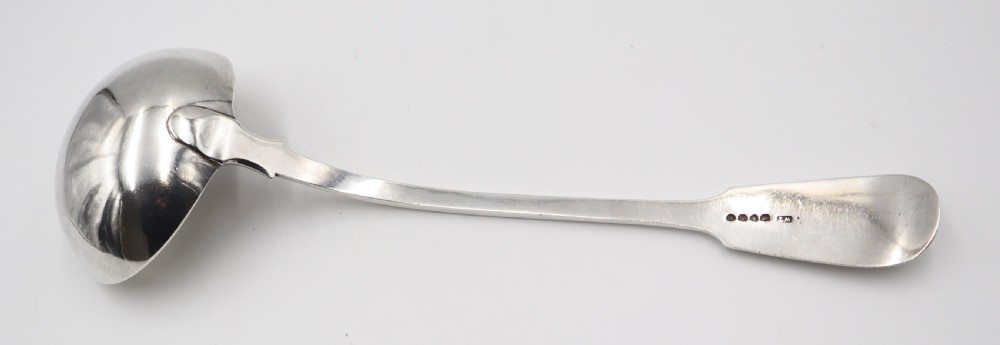 An antique silver soup ladle featuring a deep circular bowl, a slender arched stem, and a shell detail on the handle terminal. View IV