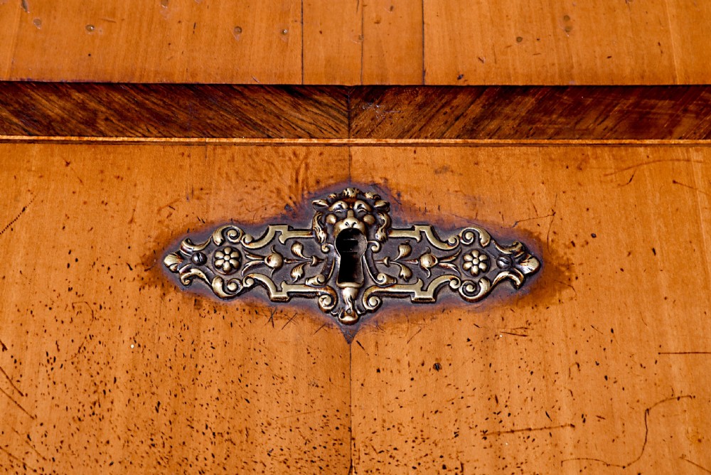 A 19th-century blonde walnut slant-front bureau featuring rosewood inlay, a central star motif on the lid, and three long drawers with decorative metal handles. View IX
