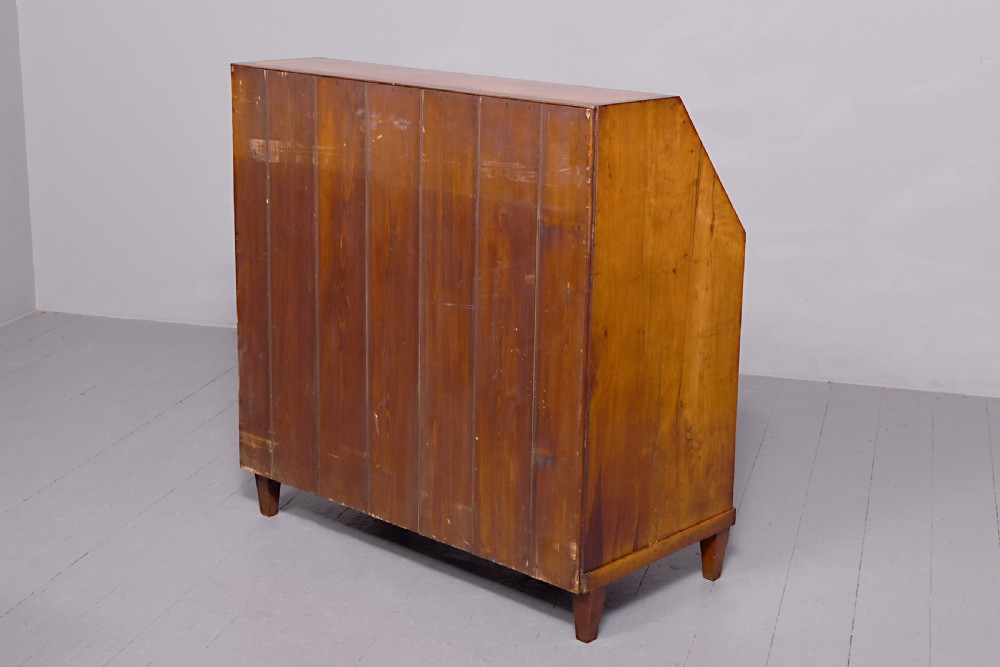 A 19th-century blonde walnut slant-front bureau featuring rosewood inlay, a central star motif on the lid, and three long drawers with decorative metal handles. View XIII
