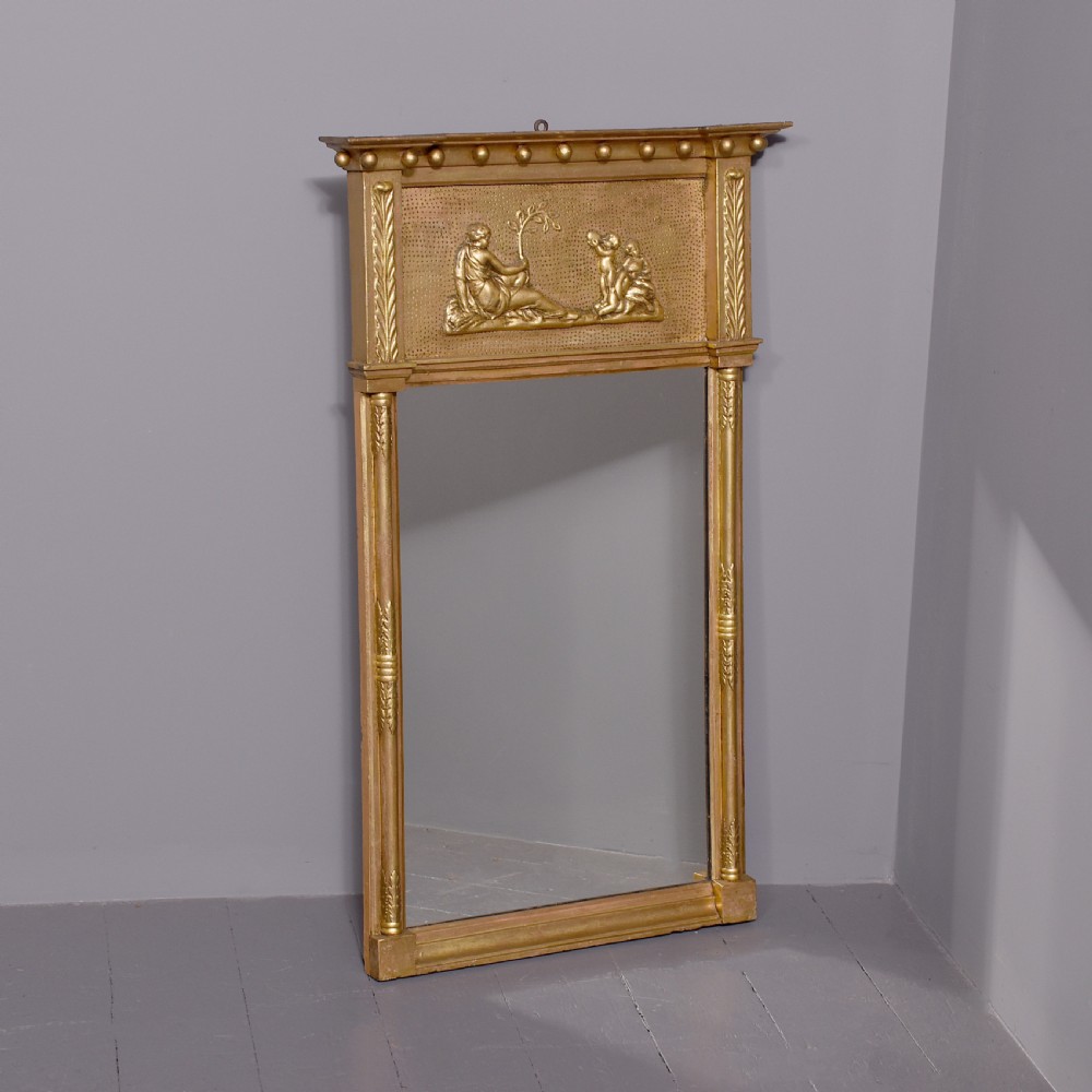 A Regency gilded wood pier mirror featuring a ball-decorated cornice, a classical figure relief frieze, and reeded side columns framing rectangular glass. View II