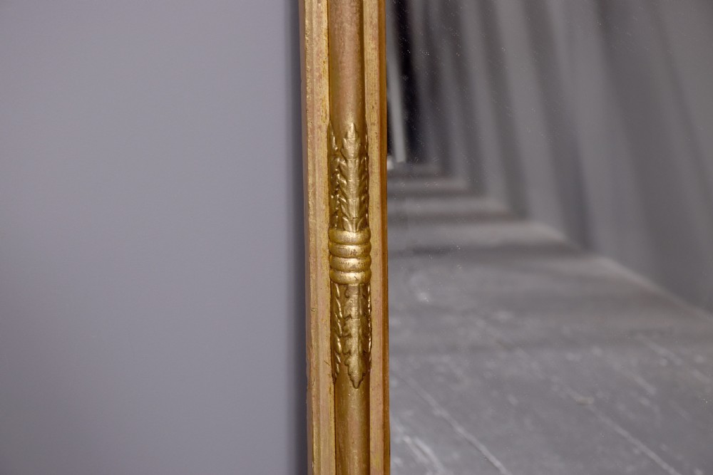 A Regency gilded wood pier mirror featuring a ball-decorated cornice, a classical figure relief frieze, and reeded side columns framing rectangular glass. View IV