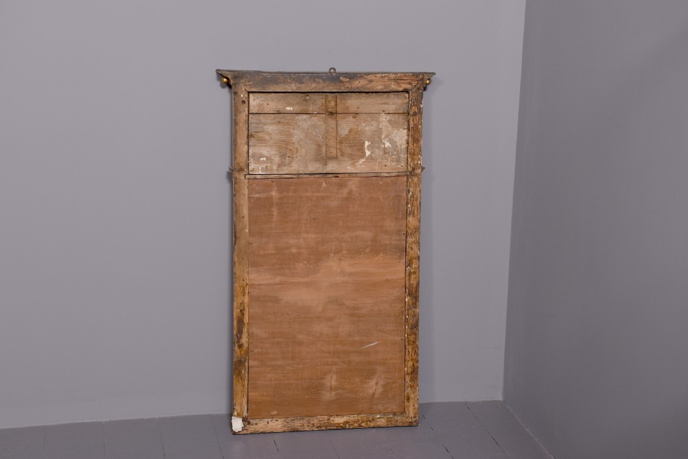 A Regency gilded wood pier mirror featuring a ball-decorated cornice, a classical figure relief frieze, and reeded side columns framing rectangular glass. View VI