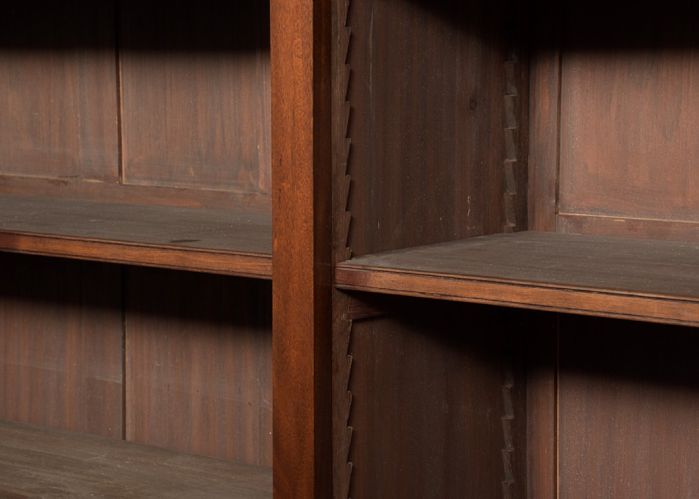 A wide dark mahogany open bookcase featuring twin double bays with multiple shelves, decorative inlay on the frieze, carved shell motifs on the lower apron, and cabriole legs ending in ball and claw feet. View III