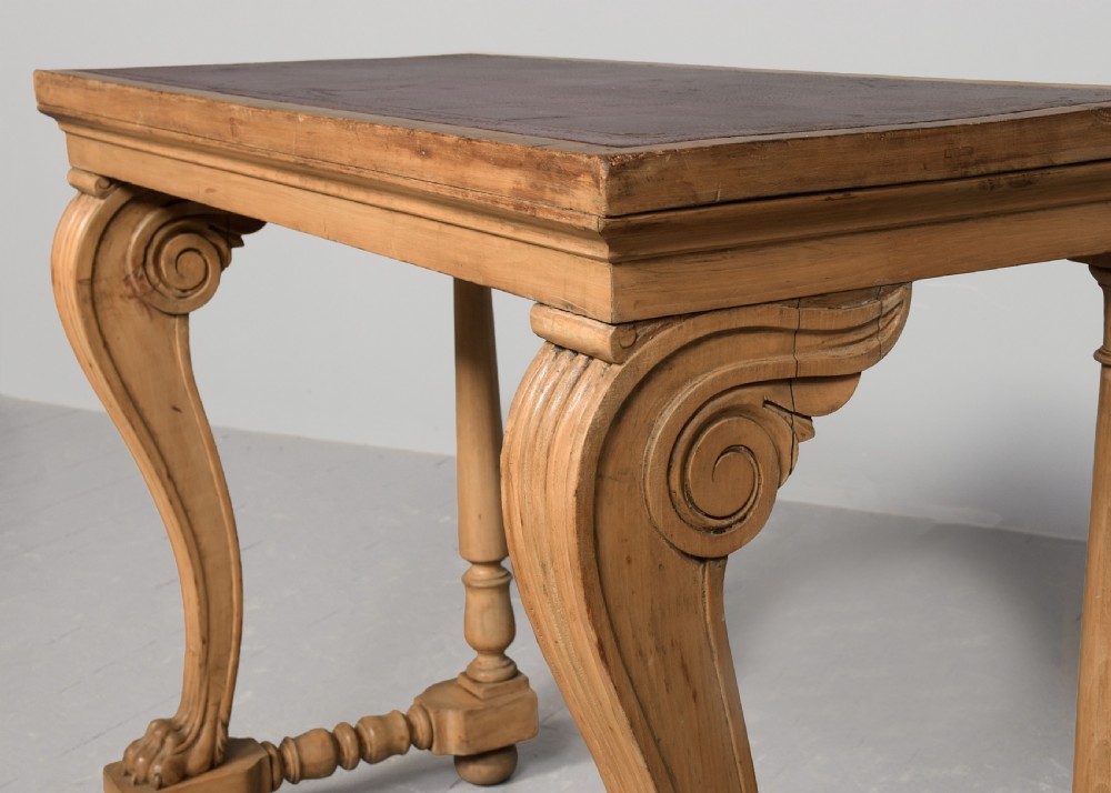 A Regency light wood console table featuring an inset reddish leather top, front scroll-carved legs with paw feet, and turned rear supports. View IV