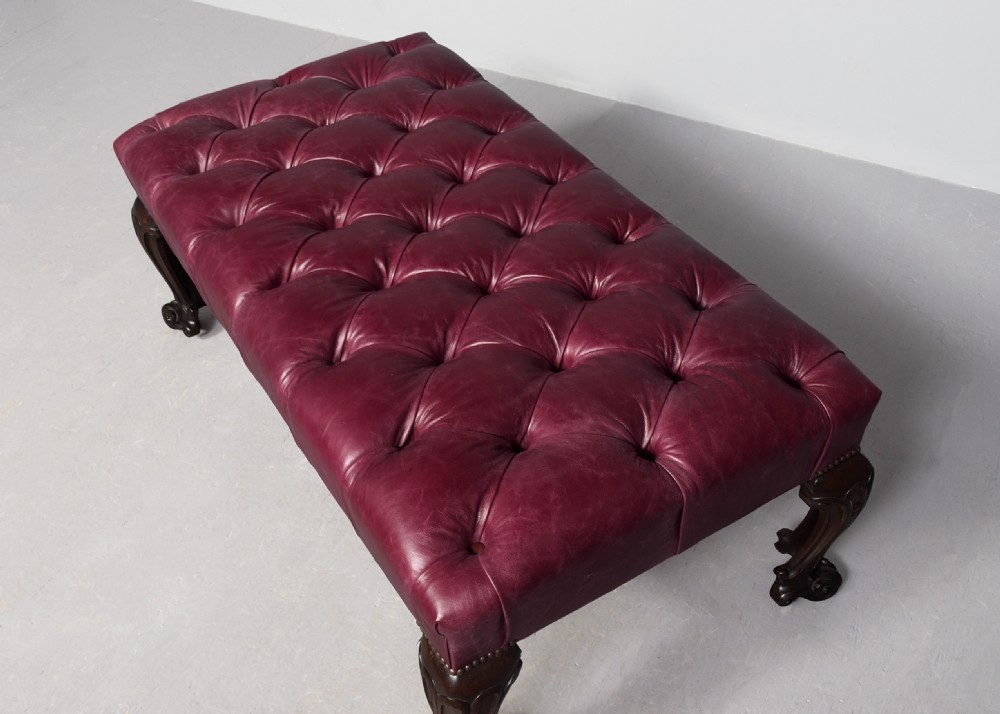 A large rectangular Georgian-style footstool upholstered in deep buttoned burgundy hide leather with mahogany cabriole legs. View III