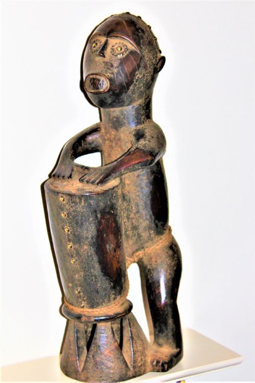 A Well Carved African Tribal Figure of a Man Beating a Drum Possibly by the Kongo People of West Central Africa