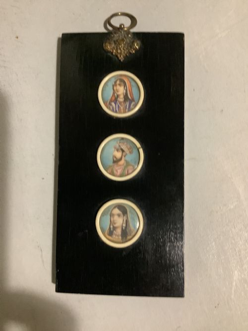 A Small Indian Ebonised Wood Painting of Three Miniatures Finely Painted on the Back of the Glass