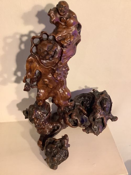 A rare and glorious piece of gnarled wood cleverly carved as a man with a boy on his shoulders