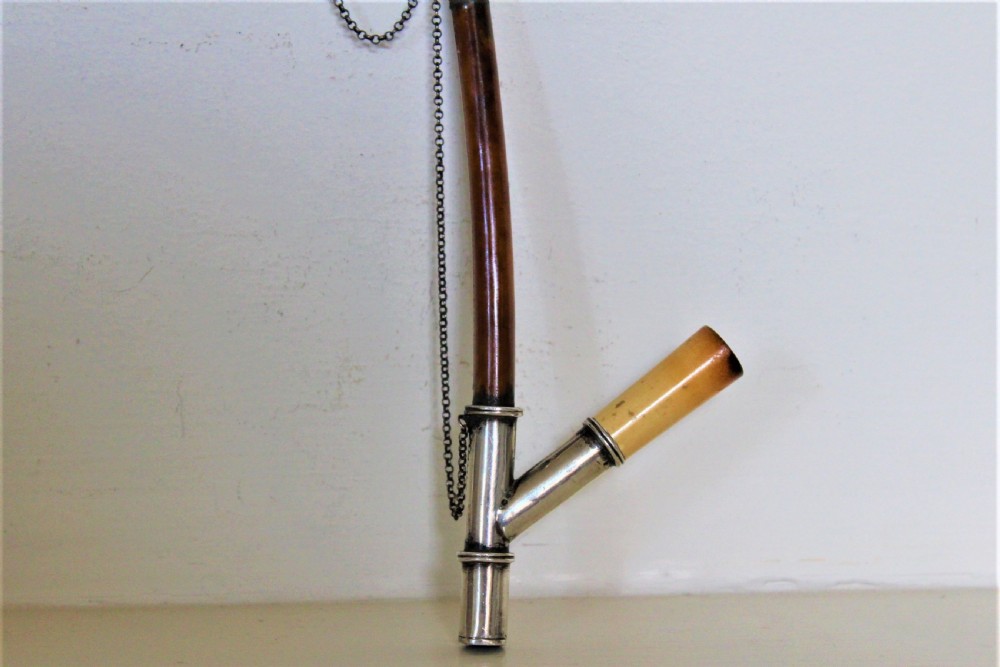 An antique smoking pipe featuring a cream-coloured meerschaum bowl connected to a dark brown quill stem with white metal joints and safety chain. View IV