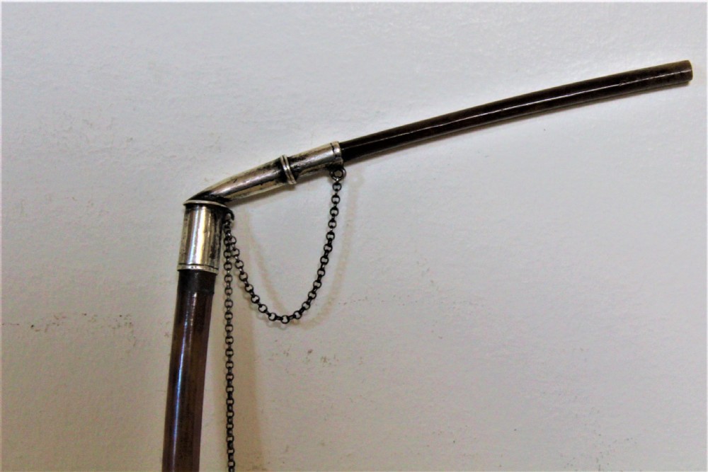 An antique smoking pipe featuring a cream-coloured meerschaum bowl connected to a dark brown quill stem with white metal joints and safety chain. View V