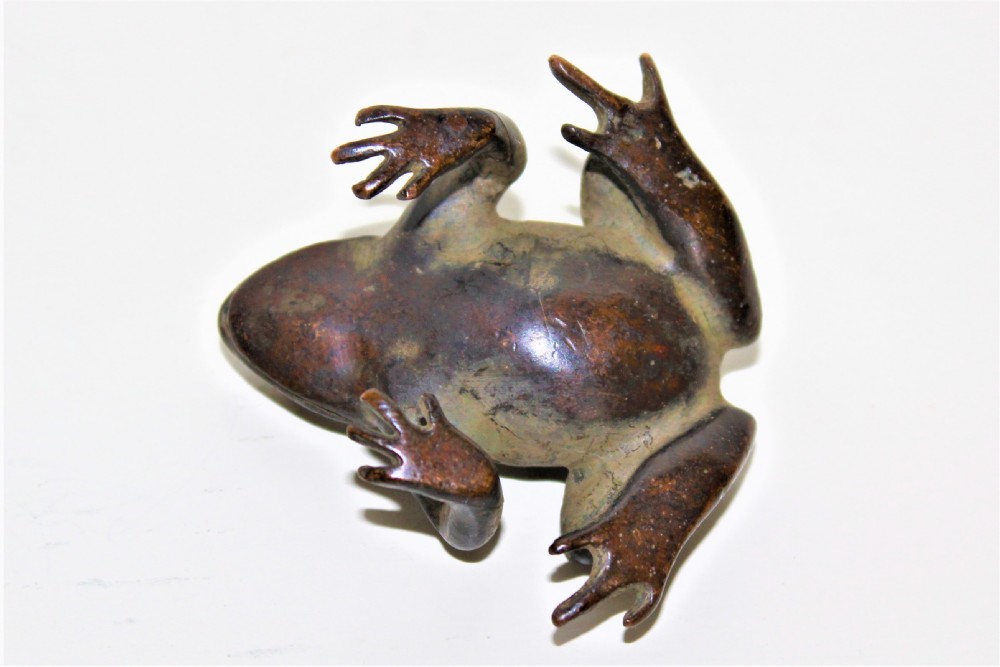 A small cast bronze study of a crouching frog displaying a patinated surface with subtle green oxidisation. View VI