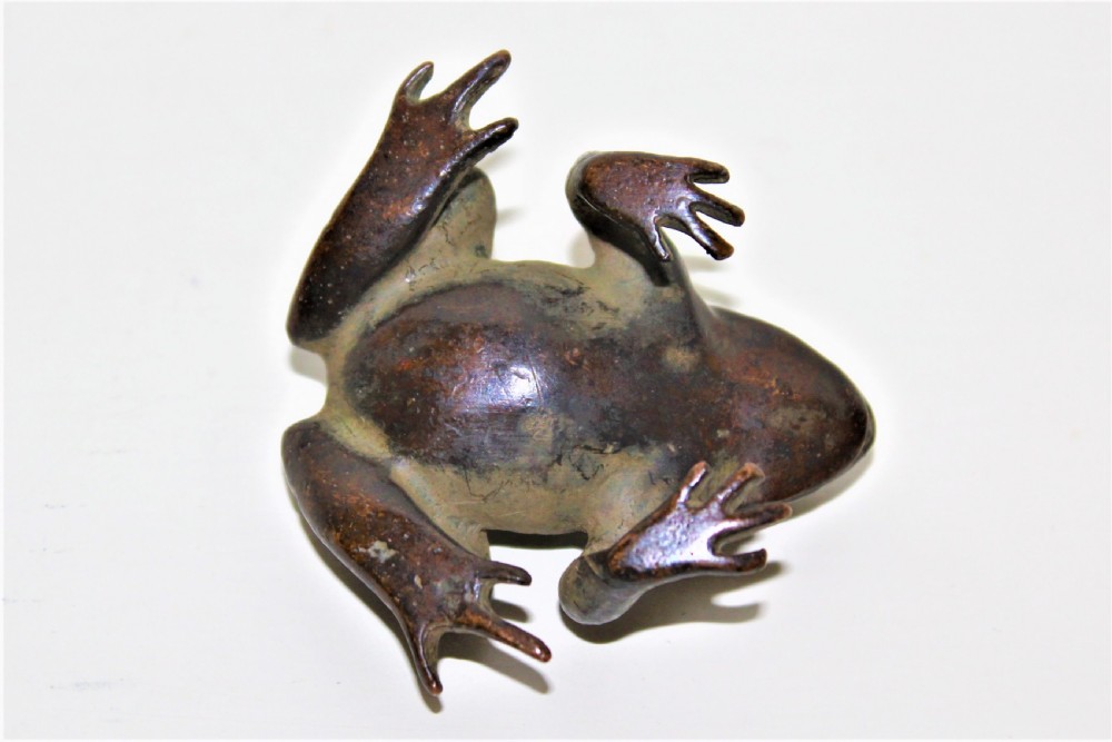 A small cast bronze study of a crouching frog displaying a patinated surface with subtle green oxidisation. View VII