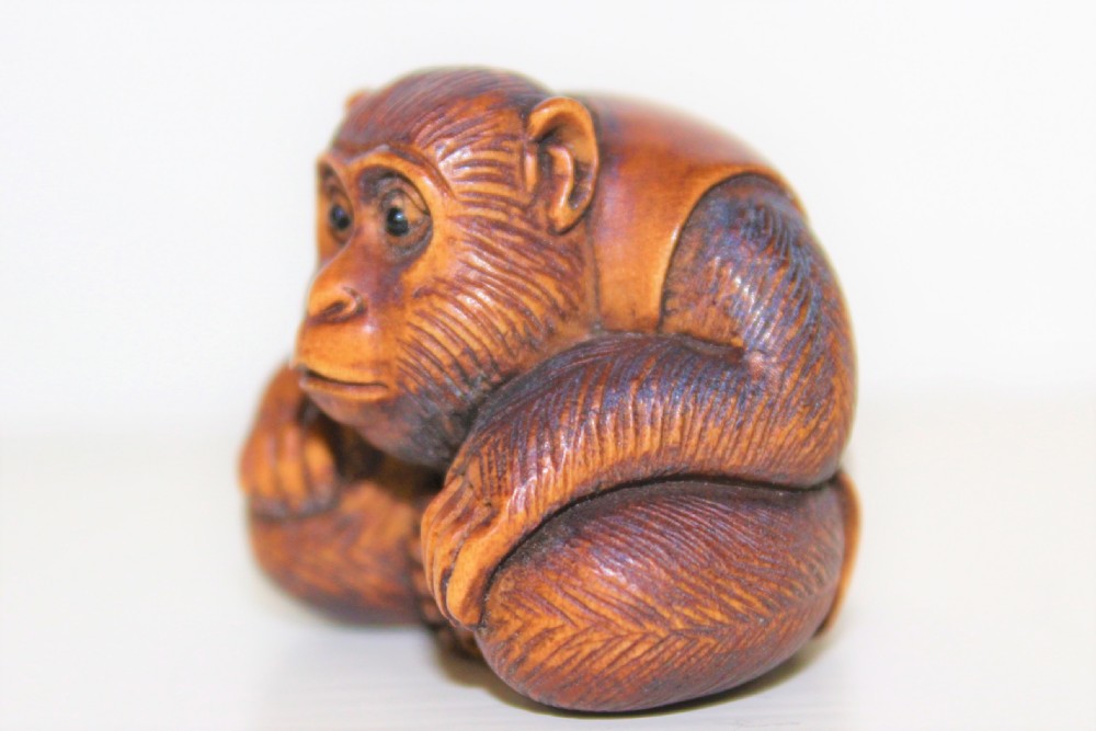 Fine quality and signed carved boxwood netsuke of a crouching monkey Meiji period 1864 to 1912 View VI