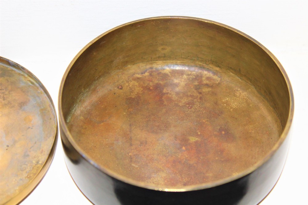 A circular brown bronze box lid decorated with high relief figures under cherry blossoms highlighted in gold and silver metal inlay. View VII