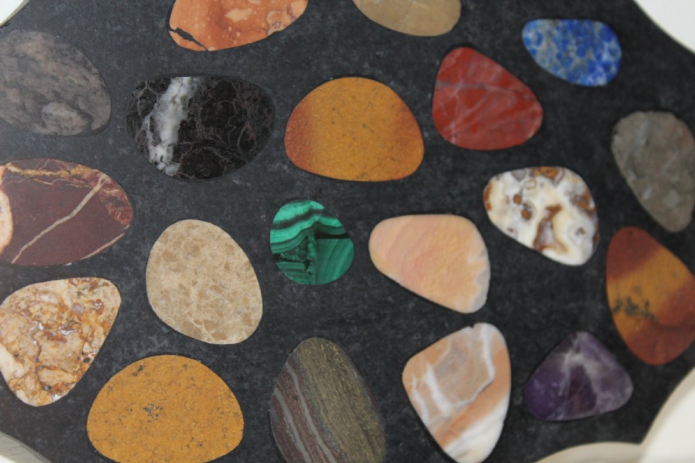 A shaped dark slate plaque inlaid with various polished colorful specimen stones including malachite and agates. View III