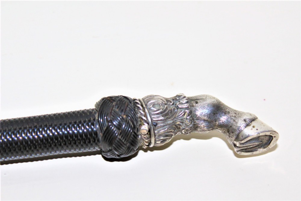 A very fine riding crop with a well cast white metal horses hoof handle and nicely woven leather shaft English Circa 1880 to 1900 View IV