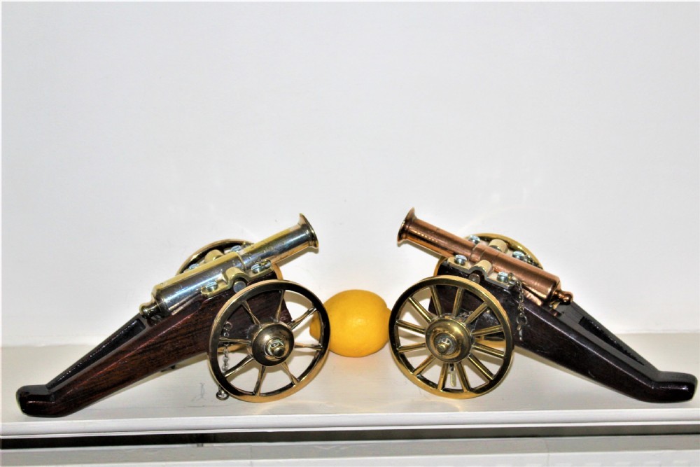 Pair of hand made heavy polished bronze desk cannons on mahogany undercarriage  English Circa 1880