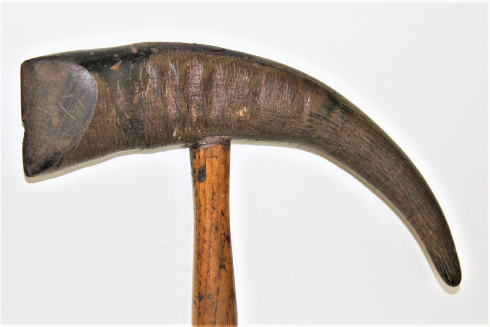A mid-19th-century Nordic ice pick featuring a curved dark goat horn head mounted perpendicularly onto a turned oak wood shaft. View IV