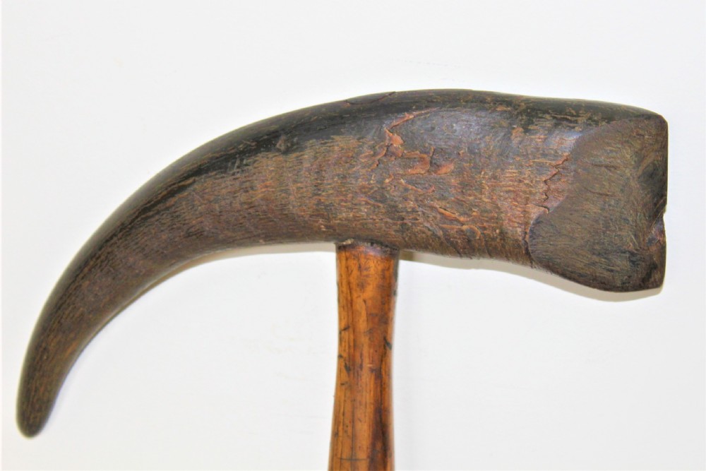 A mid-19th-century Nordic ice pick featuring a curved dark goat horn head mounted perpendicularly onto a turned oak wood shaft. View V