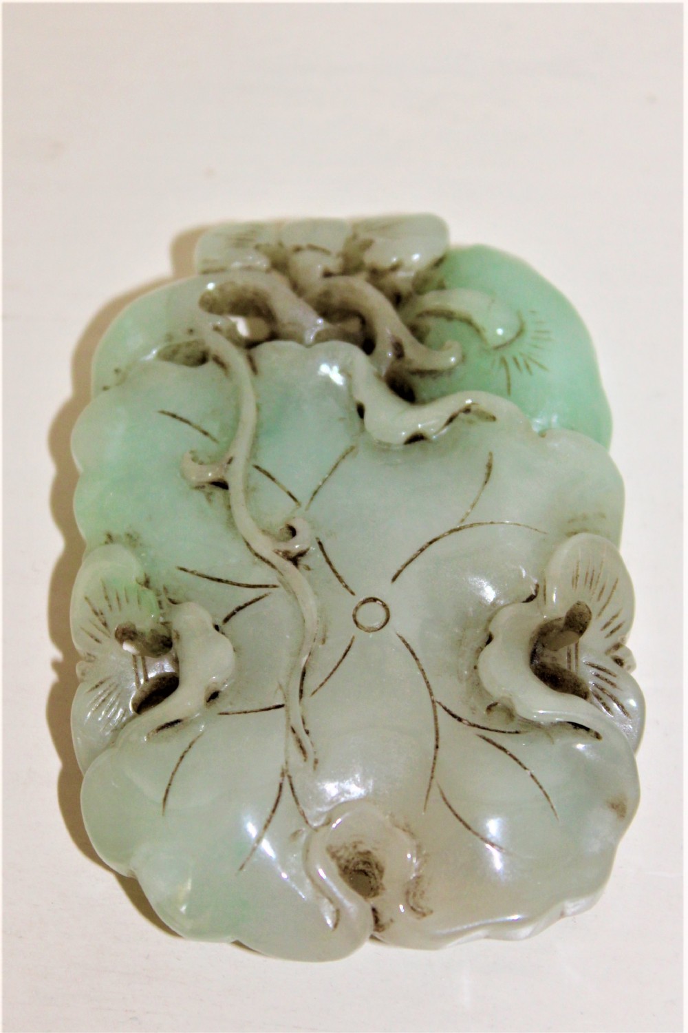 Chinese finely carved and pierced jade pendant of a lotus flower Circa 1880 to 1920