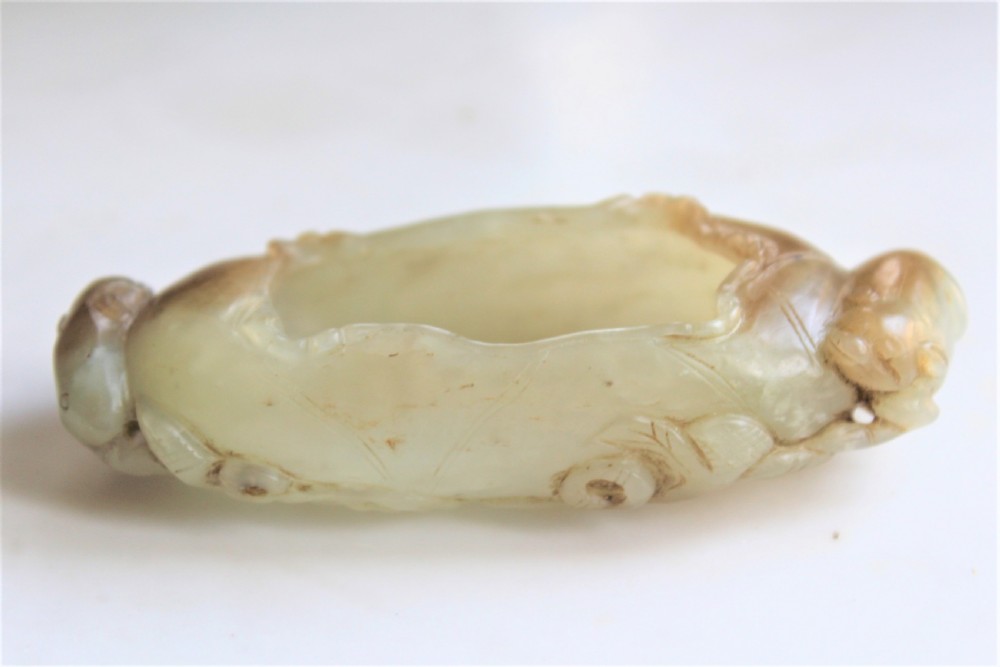 A Chinese carved jade brush washer in the form of a lily pad with an animal on each end  View III