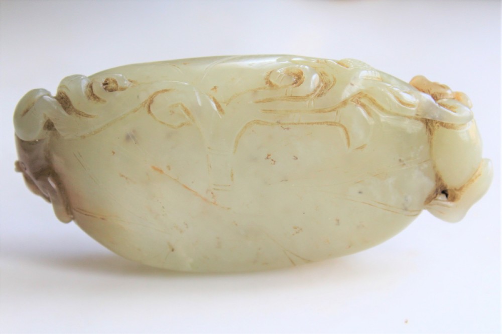 A Chinese carved jade brush washer in the form of a lily pad with an animal on each end  View II
