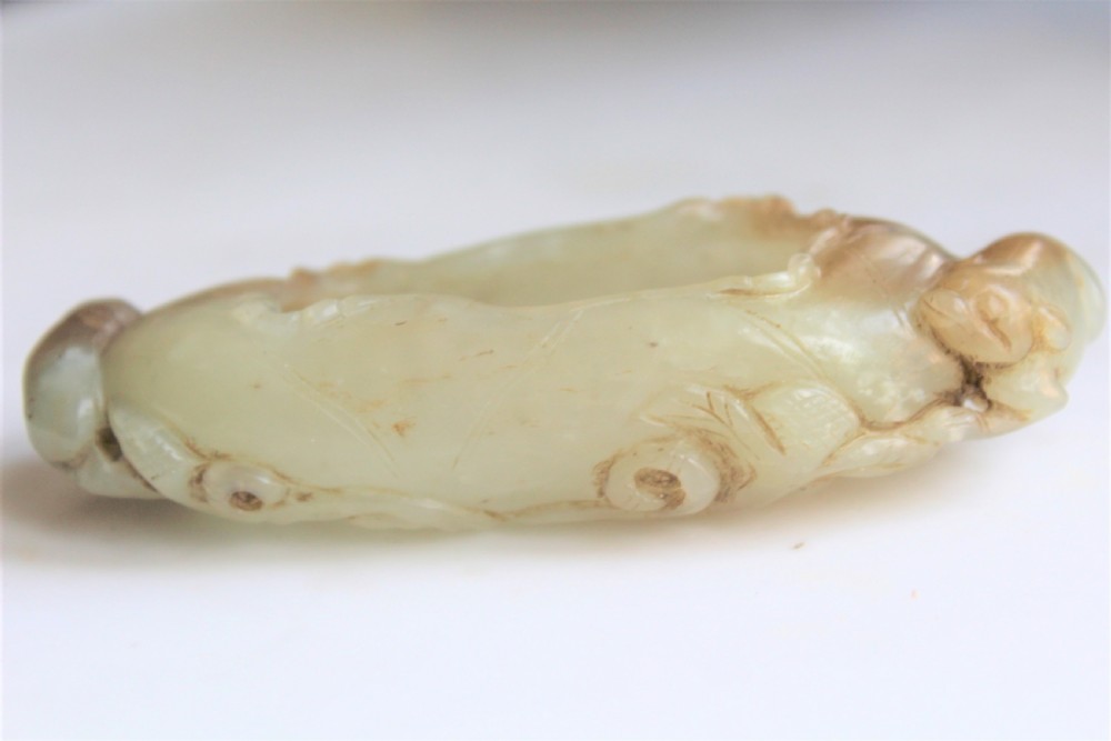 A Chinese carved jade brush washer in the form of a lily pad with an animal on each end  View IV