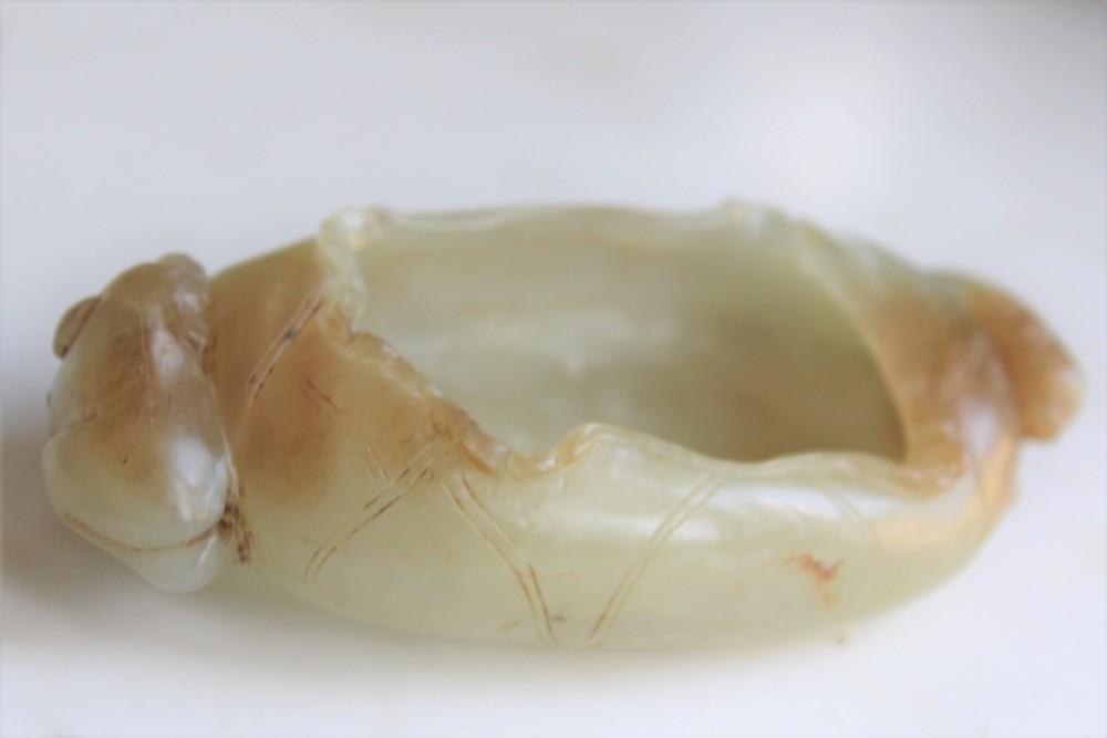 A Chinese carved jade brush washer in the form of a lily pad with an animal on each end  View V