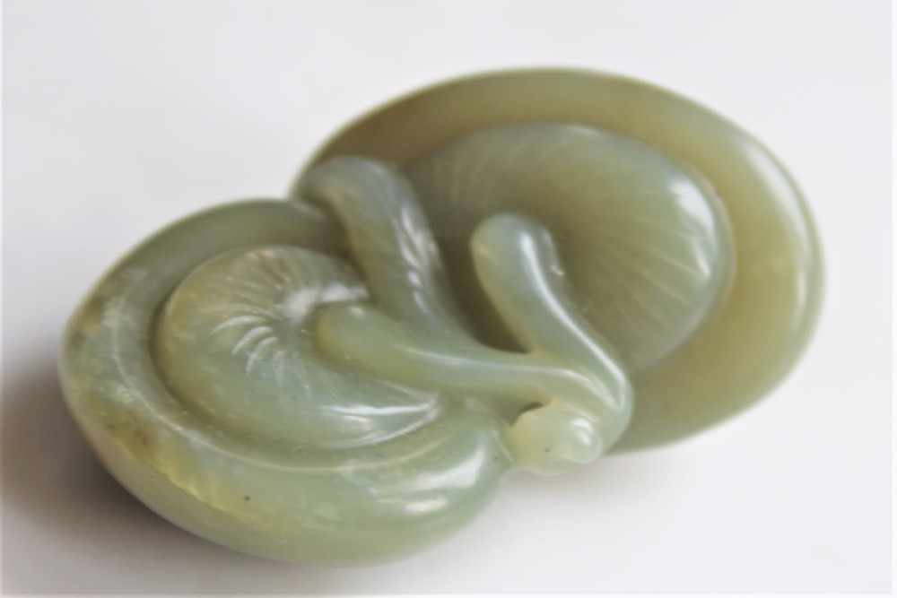 A well carved Chinese green jade Lingzhi Fungus pendant or netsuke Circa 1880 to 1920