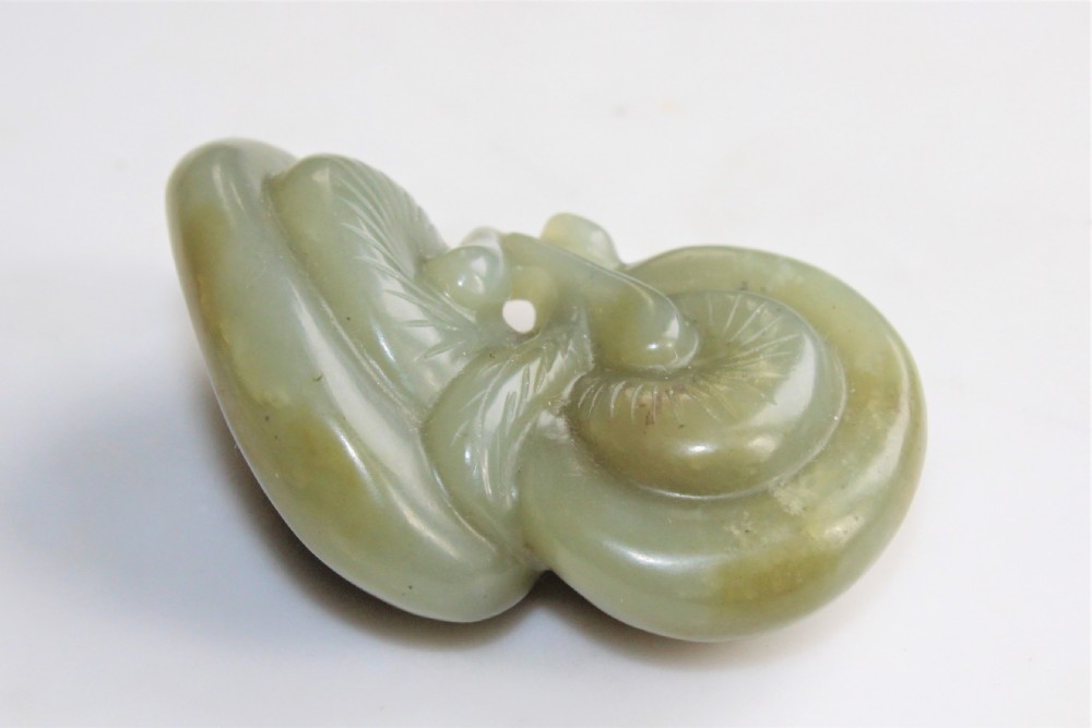 A well carved Chinese green jade Lingzhi Fungus pendant or netsuke Circa 1880 to 1920 View III